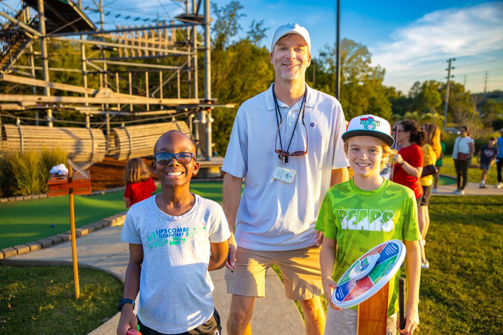 teacher and two students at mini golf